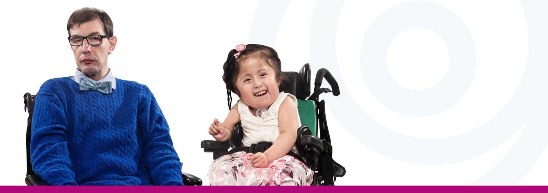 Man in a wheelchair next to little girl in a wheelchair